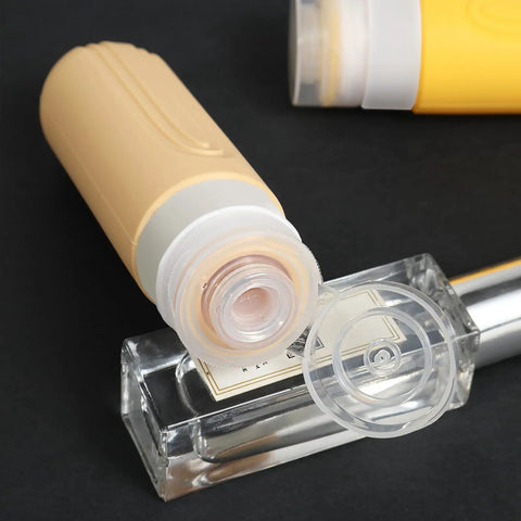 Close-up of beige silicone bottle from On The Go Travel Bottles For Toiletries Set 5 Pack TSA Approved 3oz Leak Proof Refillable Containers.