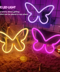 Three Piece Butterfly Neon Signs Set For Bedroom Decor Dope Battery Powered LED Neon Lights in purple, yellow, and pink glow.