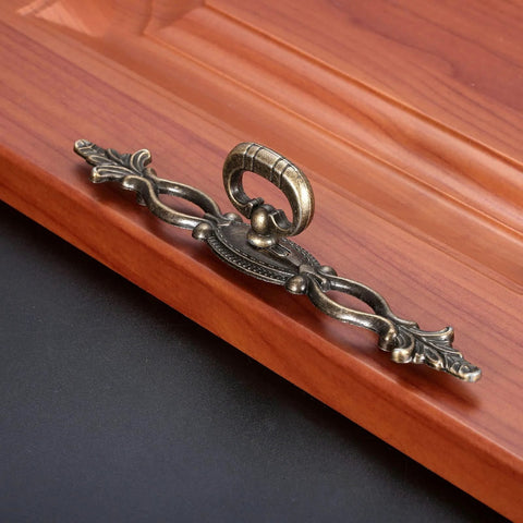 Vintage Style Antique Bronze Cabinet Pulls Handles 2 Pack Hollow Decor on wooden surface