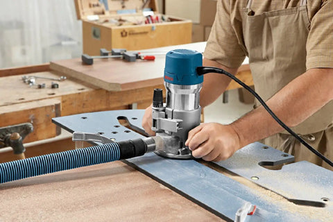 Carpenter using Half Inch Carbide Tipped 3 Flute Flush Trim Router Bit Pro Grade With Shielded Pilot Bearing on laminate table