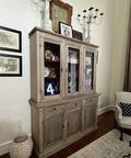 Slick Water Based Aging Wood Stain Yields Authentic Driftwood Gray Finish On a wooden cabinet in a well-decorated living room.