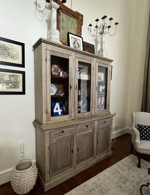 Slick Water Based Aging Wood Stain Yields Authentic Driftwood Gray Finish On a wooden cabinet in a well-decorated living room.