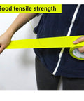 Person pulling Heavy Duty Light Yellow Packing Tape Refills, 2.5 Mil Thick for boxes, showcasing tensile strength