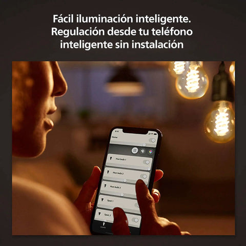 Person using smartphone to control Retro Edison Style A19 Smart LED Filament Bulb With Dimmable Glow Bluetooth Ready