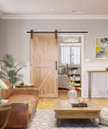 7ft Barn Door Hardware Kit with I shape hanger on a wooden sliding door in a living room, showcasing black sliding door track and steel components.