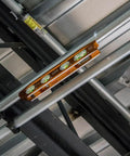 8 Inch Billet Magnetic Torpedo Level With V Groove For Precise 0 30 45 90 Degree Readings Tapered Nose High Visibility Orange Body And Secure Magnet Track For Hands Free Alignment On Metal Surfaces installed on metal pipes.