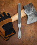 8 Inch Rectangular Axe File With Double Cut Roughing Side And Single Cut Finishing Edge next to axe and gloves