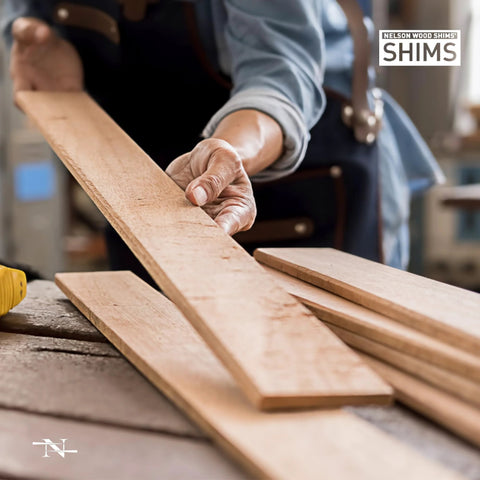 Craftsperson holding Versatile 8 Inch Wood Shims Set For DIY Projects And Home Improvement By Nelson for leveling and spacing.
