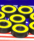 8-Pack Skateboard Sealed Ball Bearings with yellow seals, showing the smooth black finish and round design.