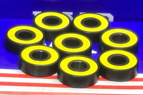8-Pack Skateboard Sealed Ball Bearings with yellow seals, showing the smooth black finish and round design.