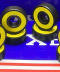 8-Pack Skateboard Sealed Ball Bearings in black with yellow seals displayed on a blue background.