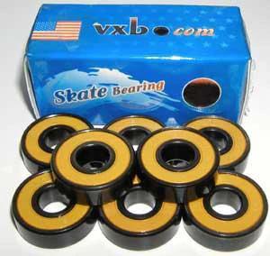 8-Pack Skateboard Black Bearings - Bronze Cage & yellow Seals 8x22x7mm arranged in front of their box.