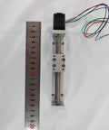 Top view of an 80mm Mini Linear Motion Actuators Lead Screw with Motor Effective Stroke Length for DIY CNC Router Parts X Y Z Linear (80MM) next to a ruler.
