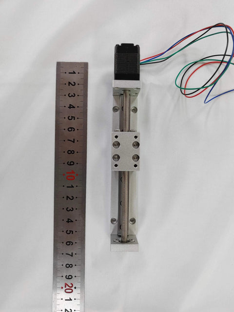 Top view of an 80mm Mini Linear Motion Actuators Lead Screw with Motor Effective Stroke Length for DIY CNC Router Parts X Y Z Linear (80MM) next to a ruler.