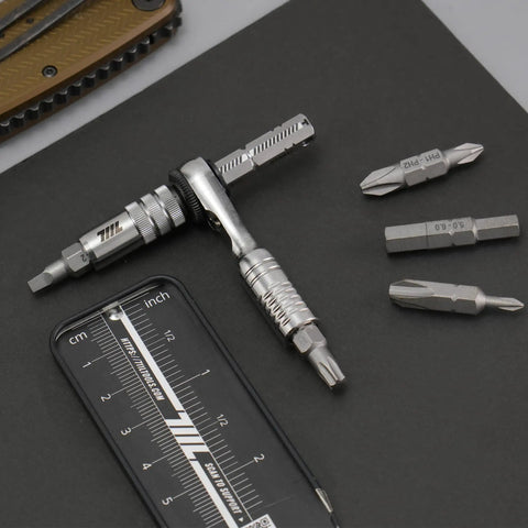 Ultra Compact One Quarter Inch Ratchet Wrench For Tight Spaces Stainless Steel EDC Tool with double ended bits on a surface