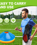 Man carrying Set Of 25 Multicolor Agility Cones With Carry Bag For Indoor And Outdoor Training on soccer field