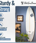 Heavy Duty Vertical Surfboard Wall Mount Rack Made From Crystal Clear Acrylic with a surfboard displayed on a wall.