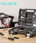All-In-One Bike Tool Kit With Storage Case, 22-Piece Bicycle Repair Set displayed open on table near road bike.