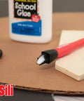 Non Stick Wood Glue Brush Silicone Applicator Kit With Comb Squeegee And Tray Reusable Silicone Glue Brushes For Woodworking Arts And Crafts Hobby Projects showing a red silicone glue brush, plywood, and bottle of glue.