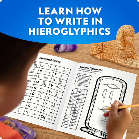 Ancient Egypt Dig Kit With Gems And Replica Artifacts For Hands On Archaeology Fun, Excavation Bricks Shaped Like Pyramid Sphinx And Pharaoh, Includes Three Real Gemstones And Three Detailed Artifacts, Learn Hieroglyphics And History. child using hieroglyphics guide with dig kit