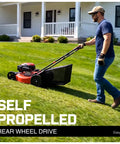Man using EasyDrive 21-Inch Self Propelled Gas Lawn Mower With 170cc 4-Stroke OHV Engine on a sloped lawn