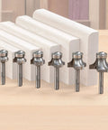 Pro Grade Three Flute Carbide Tipped Roundover Router Bit Seven Piece Set with Shear Geometry on wooden blocks.