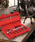 Knock Out Tough Shop Tasks With This Badass 3/8 Inch Drive 36 Piece Socket Ratchet Wrench Set Packing Smooth Chrome Steel extensions on workbench.
