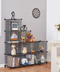 12 Cube Metal Wire Storage Organizer with stackable grid shelves in black, holding books and decor, in a living room setting