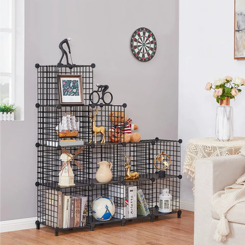 12 Cube Metal Wire Storage Organizer with stackable grid shelves in black, holding books and decor, in a living room setting
