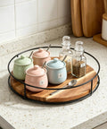 9 Inch Acacia Wood Lazy Susan Turntable with Iron Frame holding spice jars on countertop
