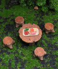 Top view of Totally Adorable Miniature Fairy Garden Furniture Set With Resin Table And Four Stump Seats Whimsical Outdoor Indoor Landscape Decor Kit For Micro Gardens on grassy surface.