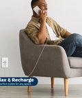 Man using phone, charging with Three Port USB Wall Outlet With Type C And Two USB A Ports, tamper resistant, in home setting.