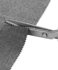 Pinking Shears 9 Inch Zigzag Craft Scissors with Decorative Edge cutting gray fabric showing sharp stainless steel blades