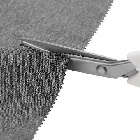 Pinking Shears 9 Inch Zigzag Craft Scissors with Decorative Edge cutting gray fabric showing sharp stainless steel blades