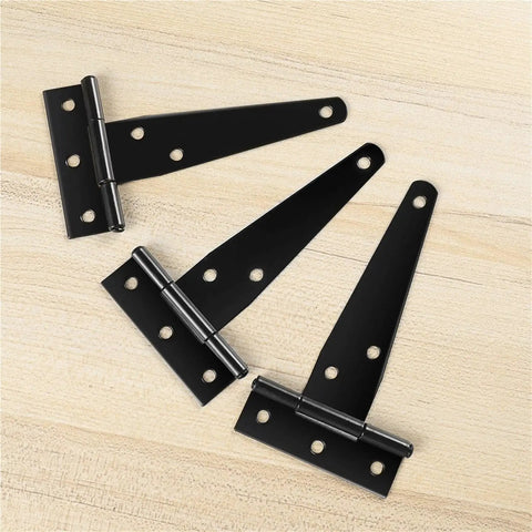 Three black 4-inch T hinges on wood, part of Six Pack 4 Inch T Hinges For Cabinets And Barn Doors Iron Lightweight Shed Hinges.