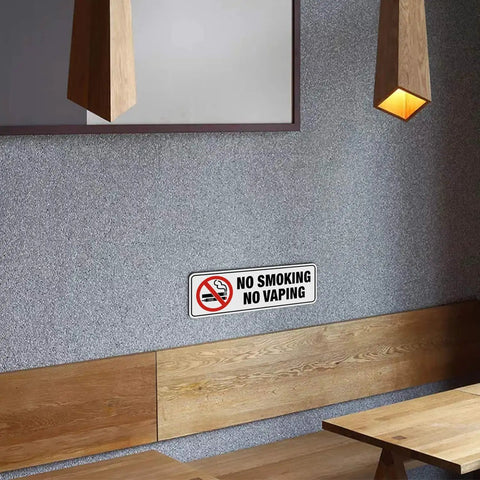 No Smoking No Vaping Sign Set Of 4, 9 By 3 Inch Stick On Wall Signs For Home Office Or Business, mounted on a wall in a modern room.