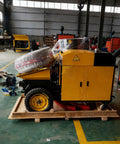 Heavy Duty Portable Concrete Pump Hydraulic Cement And Mortar Line Machine on wooden pallet in workshop.