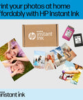 HP Instant Ink box with color and black ink cartridges surrounded by printed photos showcasing home printing capability.