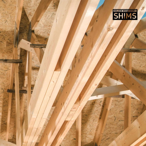 Wooden planks forming roof structure with 'Nelson Wood Shims' label visible.