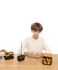 Child playing with Two Pack Remote Control Construction Vehicle Set With Friction Powered Excavator And Dump Truck Realistic Lights And Sounds For Imaginative Play Great Gift For Toddlers Boys And Girls on wooden table.