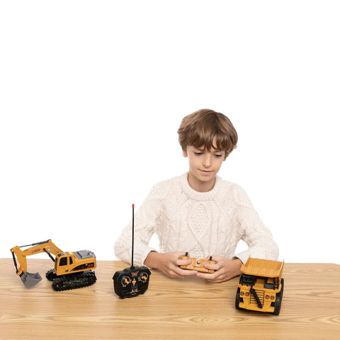 Child playing with Two Pack Remote Control Construction Vehicle Set With Friction Powered Excavator And Dump Truck Realistic Lights And Sounds For Imaginative Play Great Gift For Toddlers Boys And Girls on wooden table.