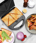 Aigostar 3 In 1 Electric Sandwich Maker With Removable Nonstick Plates Panini Press Grill And Waffle Iron 750W preparing toasted sandwiches.
