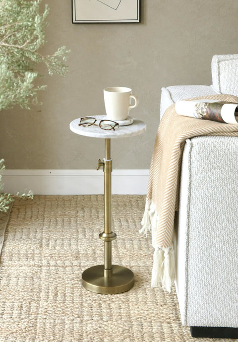 Adjustable Height Marble Drink Table With White Marble Top And Antique Brass Pedestal beside sofa, cup and glasses on top