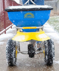 Person using Spyker Winter Weather Deicing Kit With Ergo Pro 50 Pound Spreader on snowy sidewalk