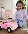 Child playing with Ford Bronco Remote Control RC Car for Barbie with Puppy Accessories, pink exterior, stickers visible.