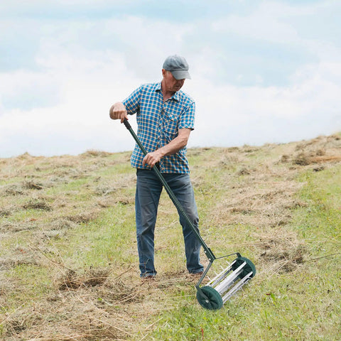 Man using Rolling Lawn Aerator 18 Inch Rotary Push Tine Spike Soil Aerator With 3 Piece Long Steel Handle on grassy lawn