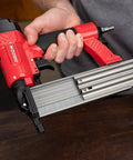 Person holding Oil Free 18 Gauge Pneumatic Brad Nailer for Small Trim and Interior Molding Fires Up to 100 PSI Handles 5/8 to 2 Inch