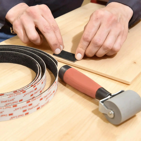 Applying Heavy Duty Reclosable Fastener Tape Featuring Rock Solid Grip Mushroom Stem Mount Strips to wood surface.