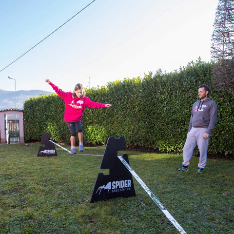 Outdoor Slackline Starter Kit With Two Frame Stands Three Height Settings from 12 to 20 Inches used by child and adult outdoors