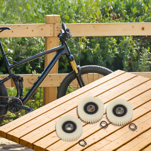 Three Beefed Up 36 Tooth Planetary Gear Set For Hub Motor E Bike With Nylon Stainless Steel Gears on wooden table near bike